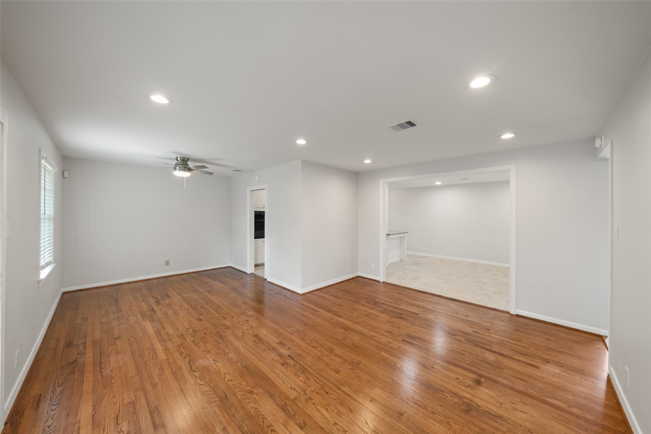 9779 Westview Drive Houston, TX 77055 - Photo 15 of 27 a view of empty room with wooden floor