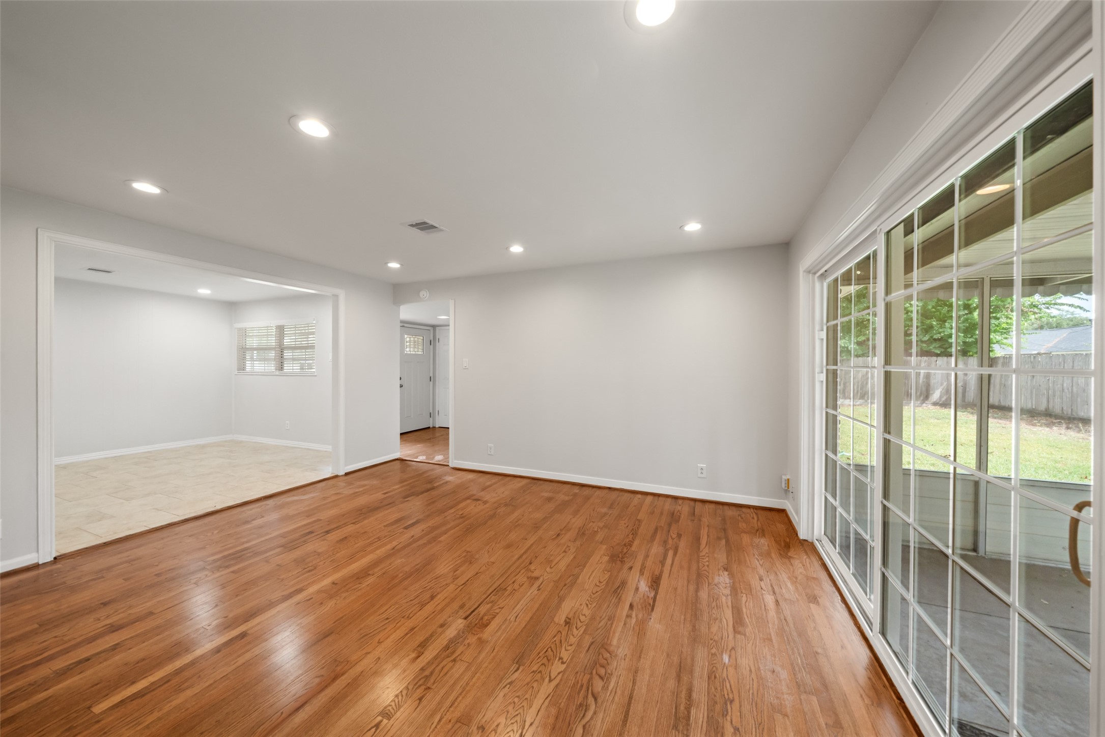 9779 Westview Drive Houston, TX 77055 - Photo 17 of 27 a view of an empty room with wooden floor and a window