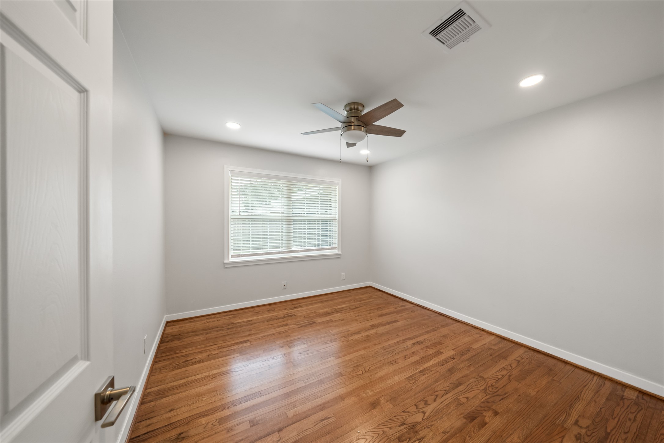 9779 Westview Drive Houston, TX 77055 - Photo 18 of 27 an empty room with a window and a fan
