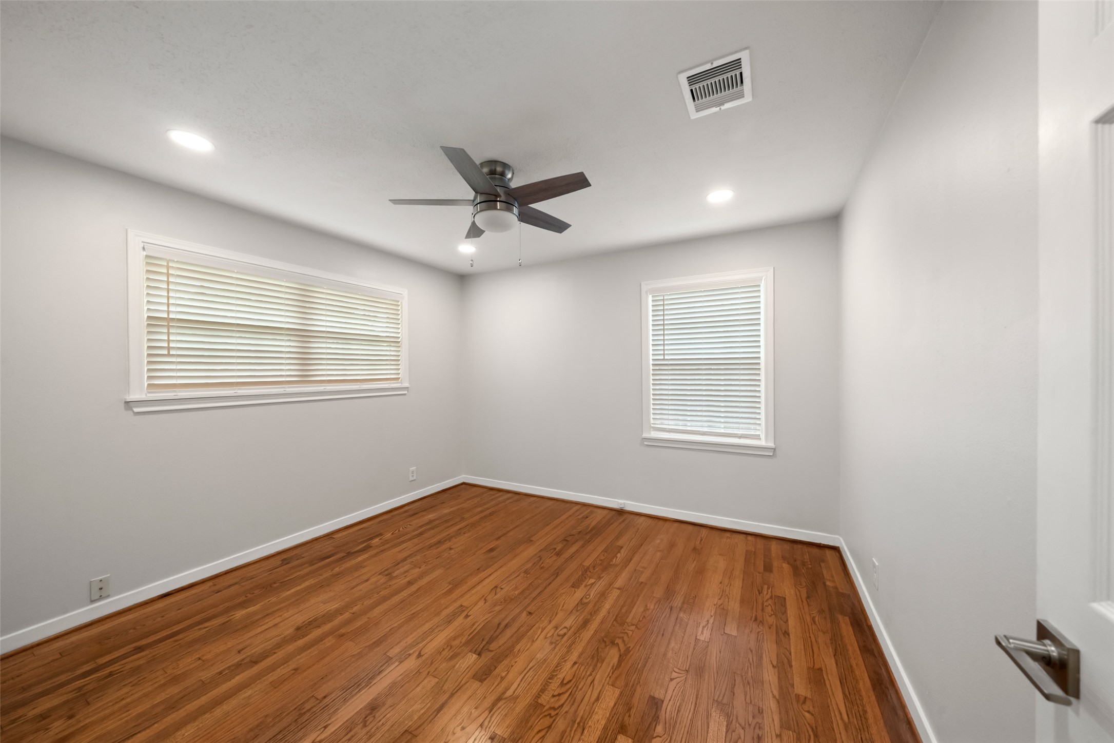 9779 Westview Drive Houston, TX 77055 - Photo 20 of 27 a view of a room with wooden floor and windows