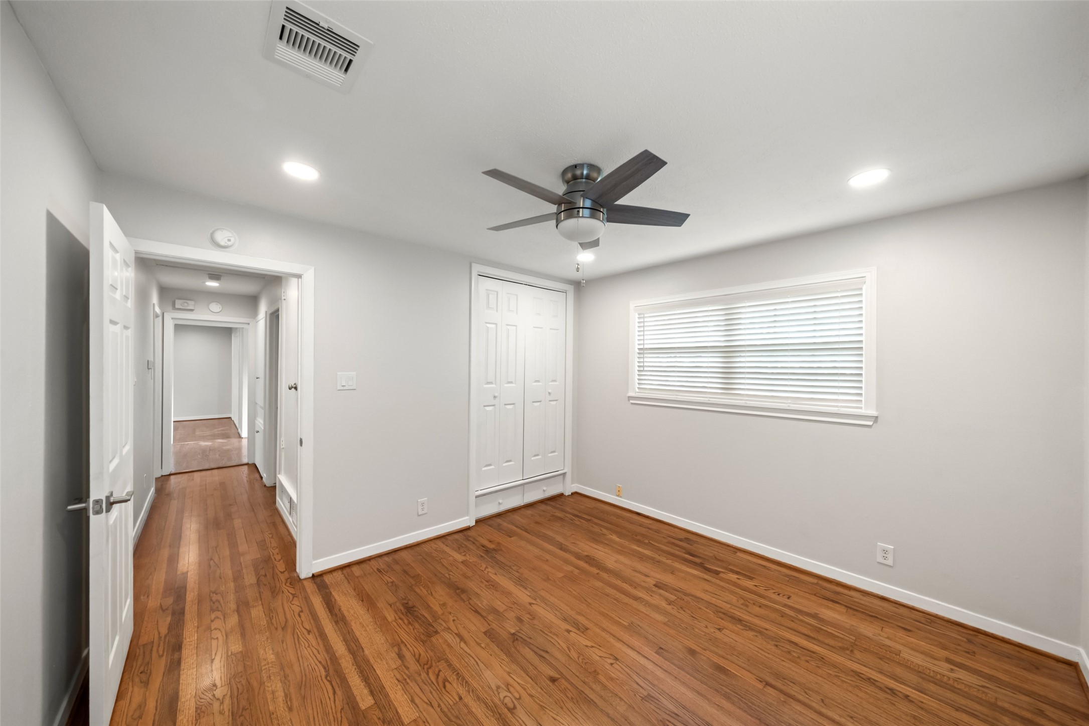 9779 Westview Drive Houston, TX 77055 - Photo 21 of 27 a view of a room with wooden floor and a ceiling fan