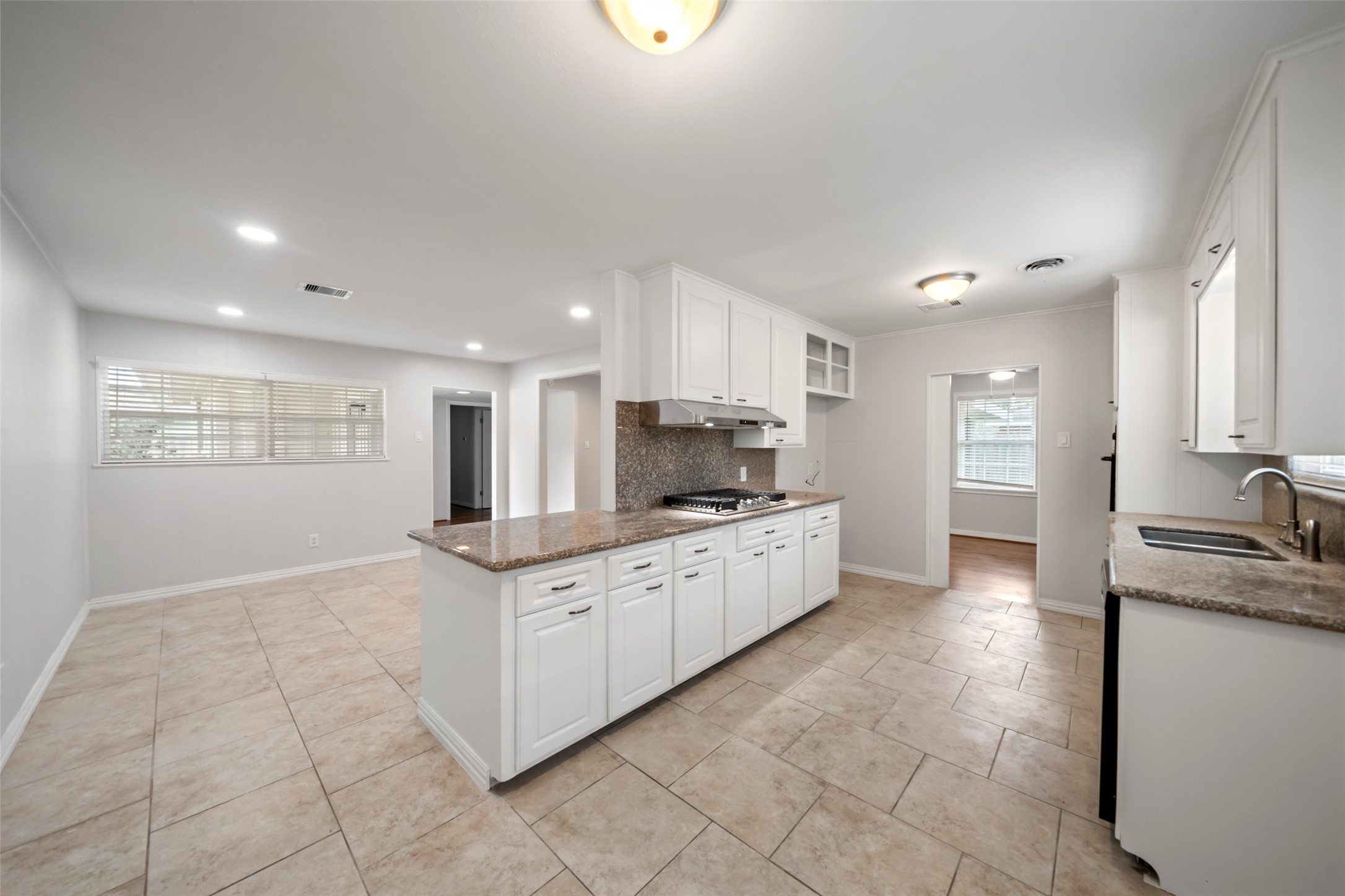 9779 Westview Drive Houston, TX 77055 - Photo 3 of 27 a kitchen with granite countertop a sink and cabinets