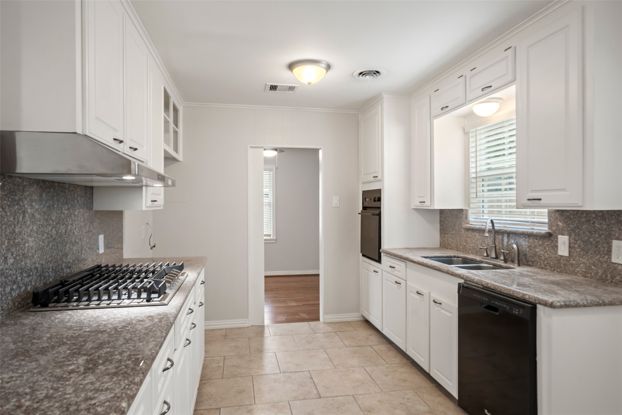 9779 Westview Drive Houston, TX 77055 - Photo 5 of 27 a kitchen with a sink stove and cabinets