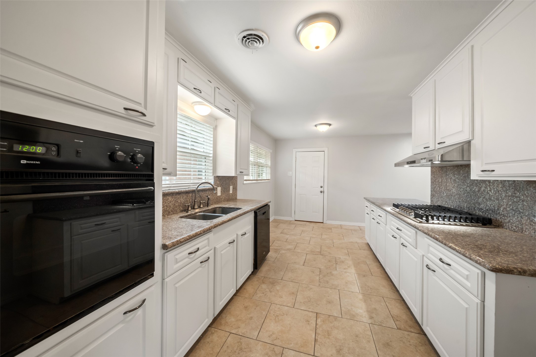 9779 Westview Drive Houston, TX 77055 - Photo 6 of 27 a large kitchen with a stove and a sink