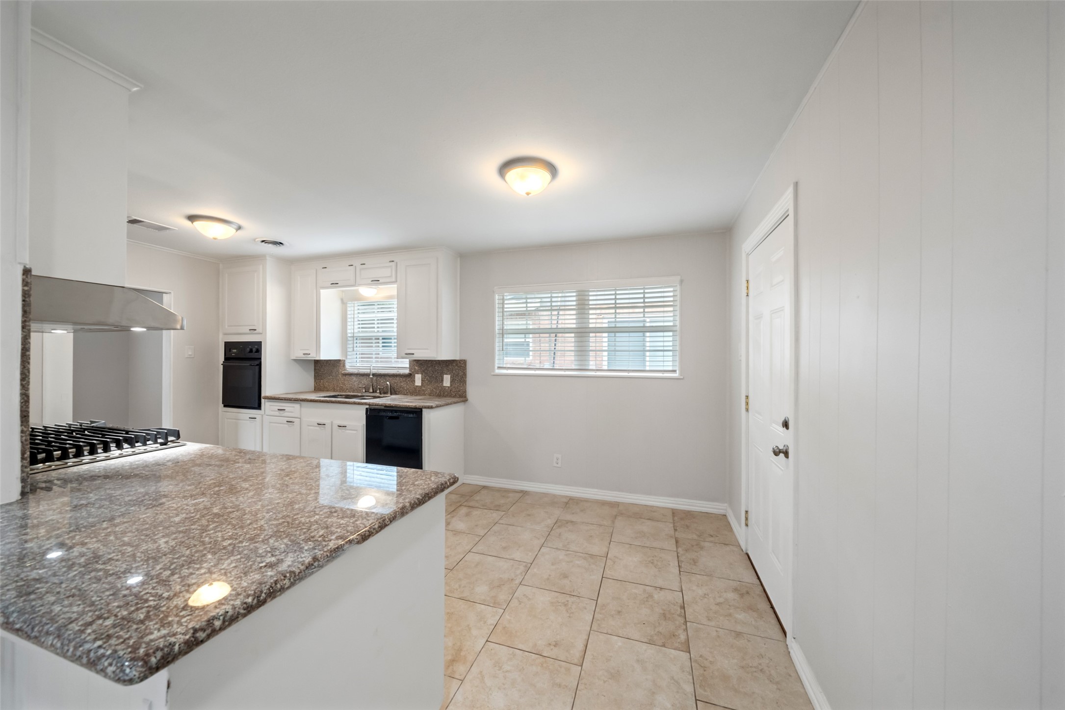 9779 Westview Drive Houston, TX 77055 - Photo 9 of 27 a kitchen with stainless steel appliances granite countertop a sink stove and cabinets