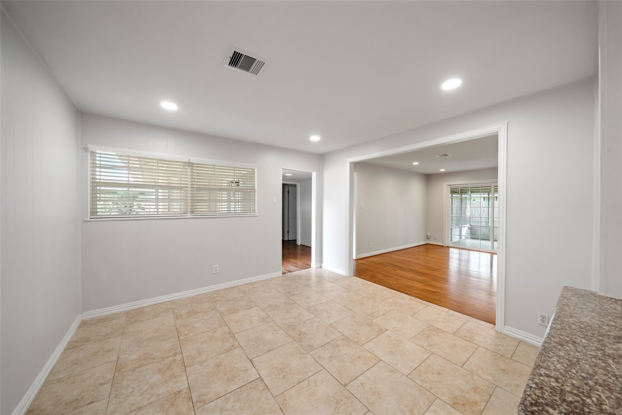 9779 Westview Drive Houston, TX 77055 - Photo 10 of 27 a view of an empty room with wooden floor and a window