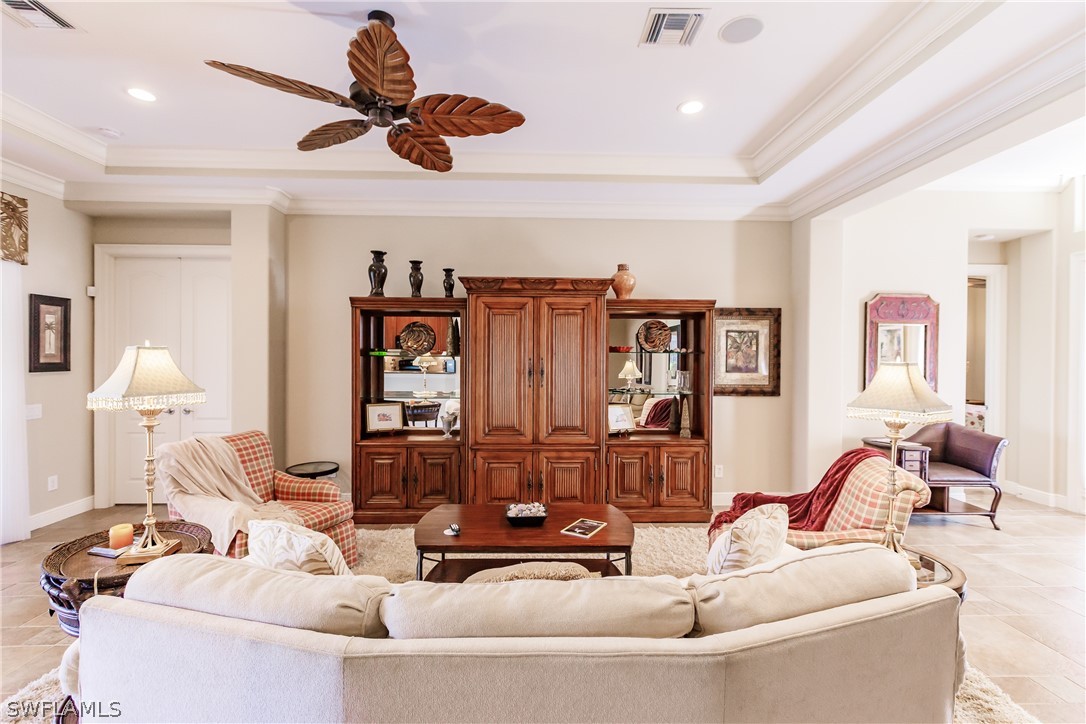 a living room with furniture and ceiling fan