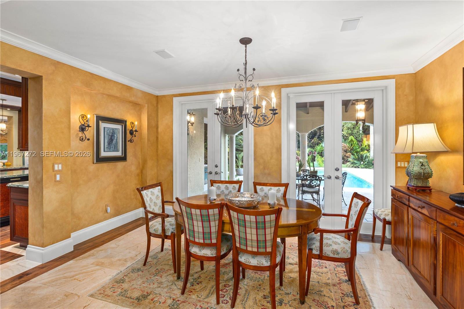 4867 Southwest 82nd Street Miami, FL 33143 - Photo 20 of 65 a view of a dining room with furniture wooden floor and chandelier