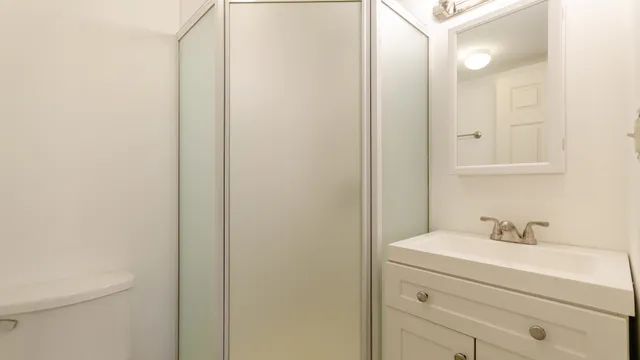 a bathroom with a sink mirror and vanity
