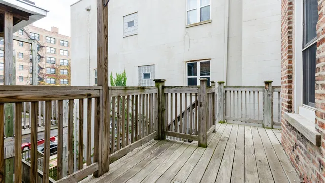 a view of a balcony with wooden floor