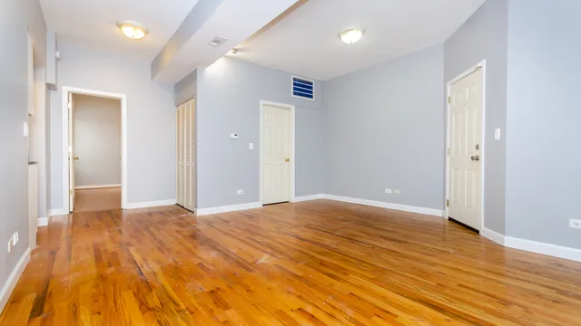 a view of an empty room and wooden floor
