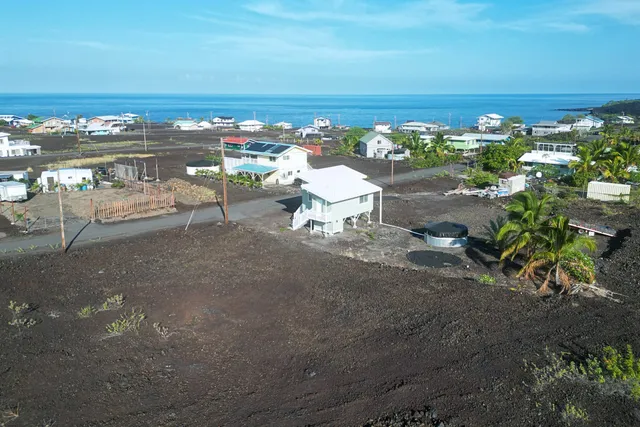 a view of a terrace with lawn chairs
