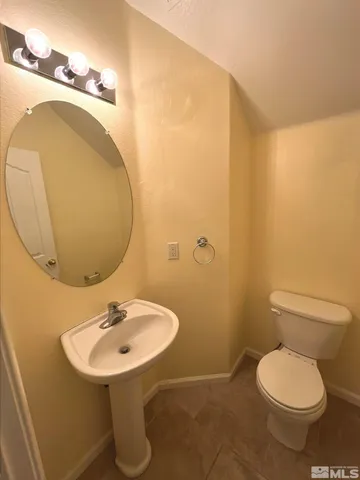 a bathroom with a sink mirror and toilet
