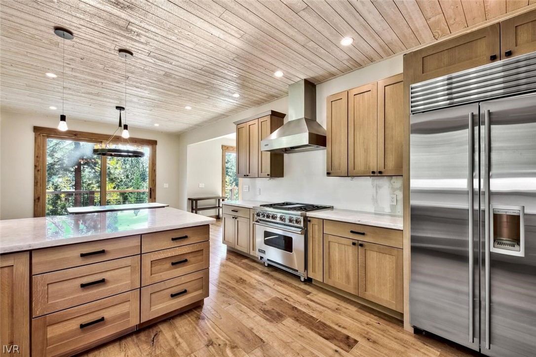 a kitchen with granite countertop cabinets stainless steel appliances and wooden floor