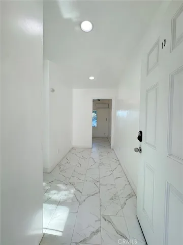 a view of a big room with wooden floor and windows