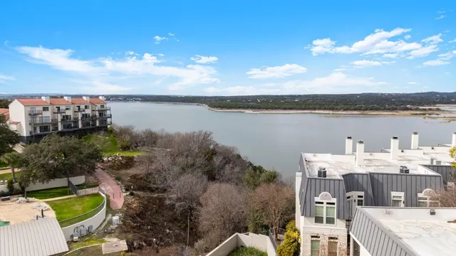 a view of a lake with couches and city view