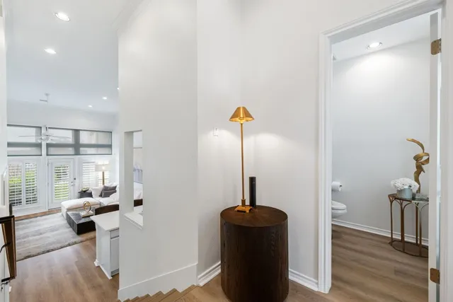 a living room with furniture and a wooden floor