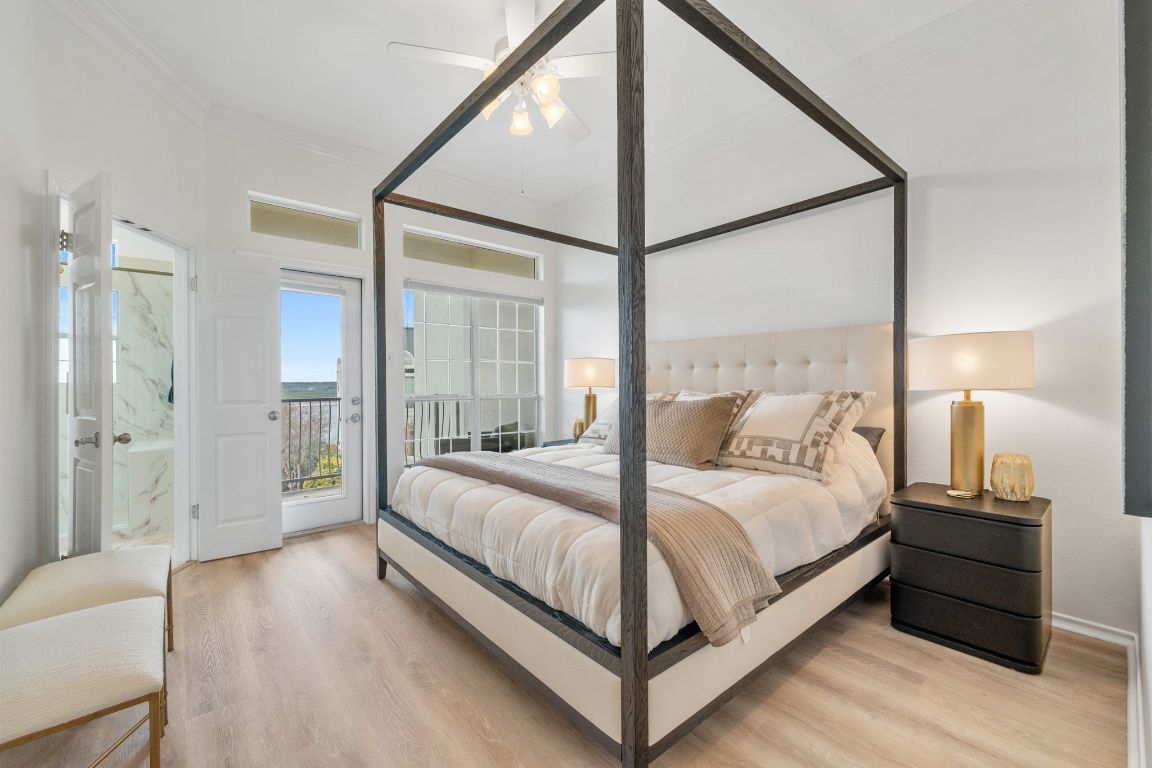 2918 Ranch Road 620, Unit 161 Austin, TX 78734 - Photo 16 of 35 a bedroom with a bed lamp closet a mirror and a large window