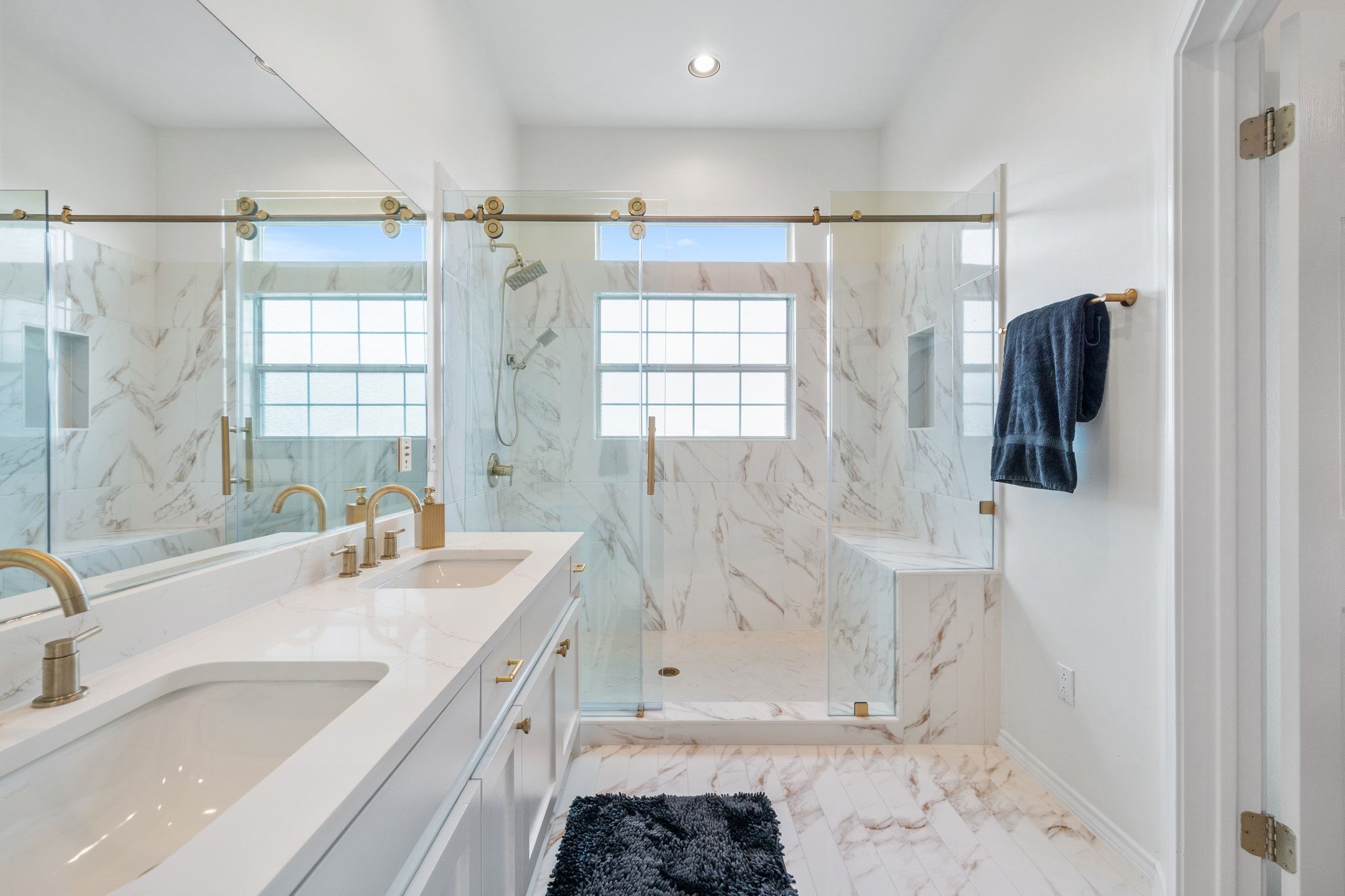 2918 Ranch Road 620, Unit 161 Austin, TX 78734 - Photo 20 of 35 a bathroom with a granite countertop sink a mirror a shower and a bathtub