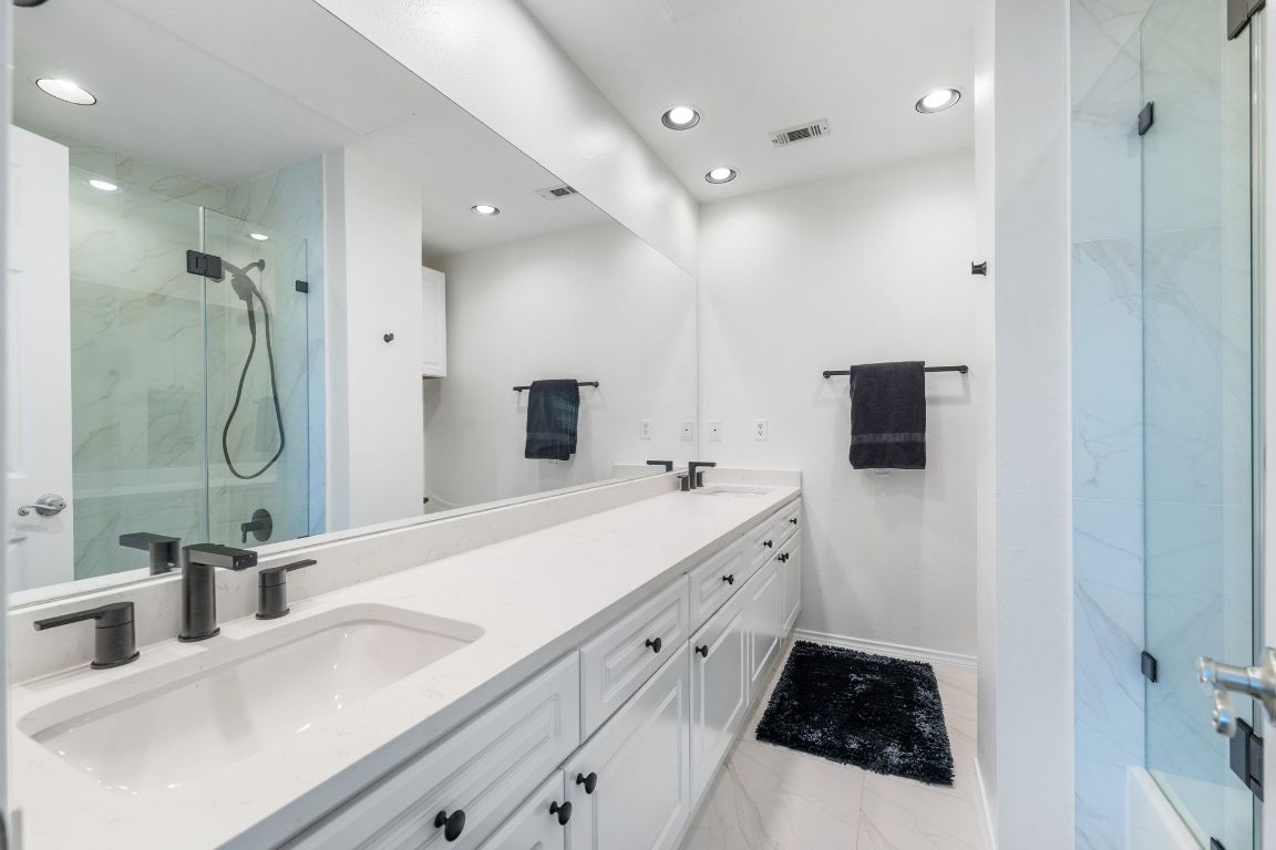 2918 Ranch Road 620, Unit 161 Austin, TX 78734 - Photo 24 of 35 a spacious bathroom with a double vanity sink a mirror and shower