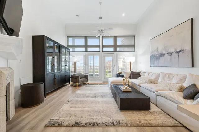 a living room with furniture large window and flat screen tv