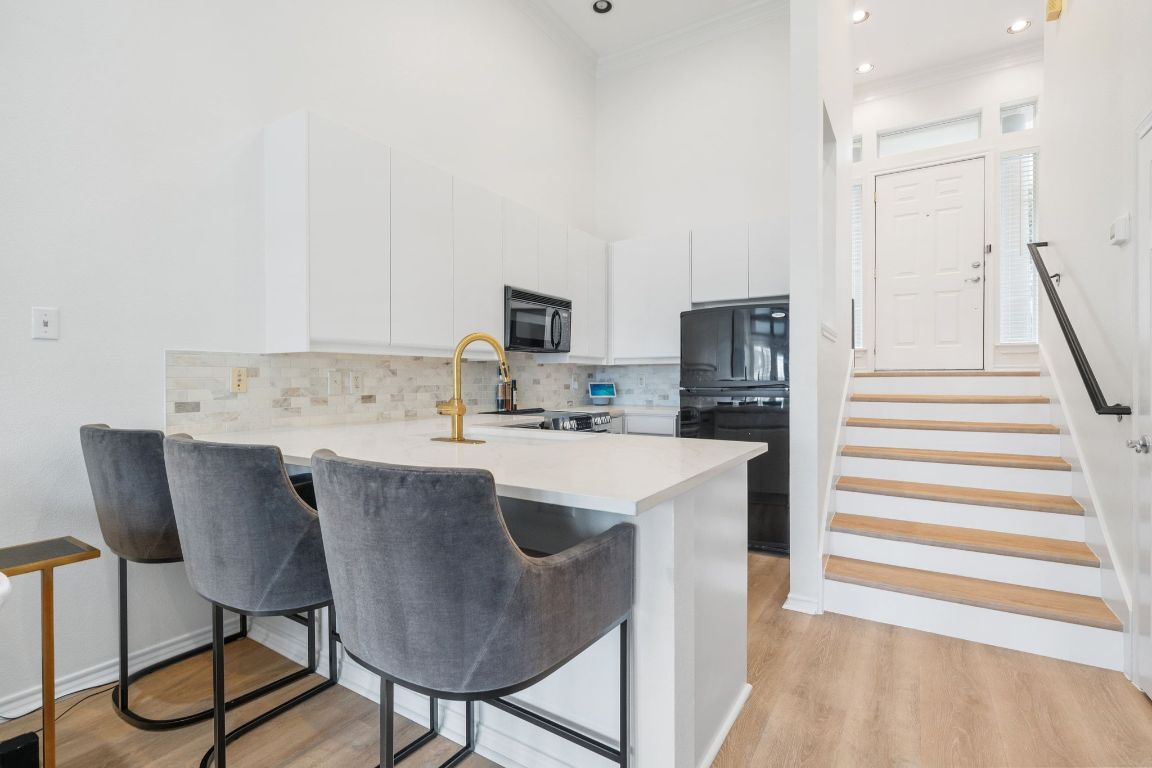 2918 Ranch Road 620, Unit 161 Austin, TX 78734 - Photo 8 of 35 a kitchen with kitchen island a sink cabinets and appliances