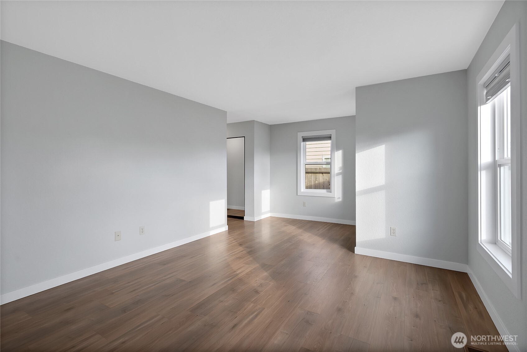 2881 Initial Avenue Enumclaw, WA 98022 - Photo 12 of 25 an empty room with wooden floor and windows