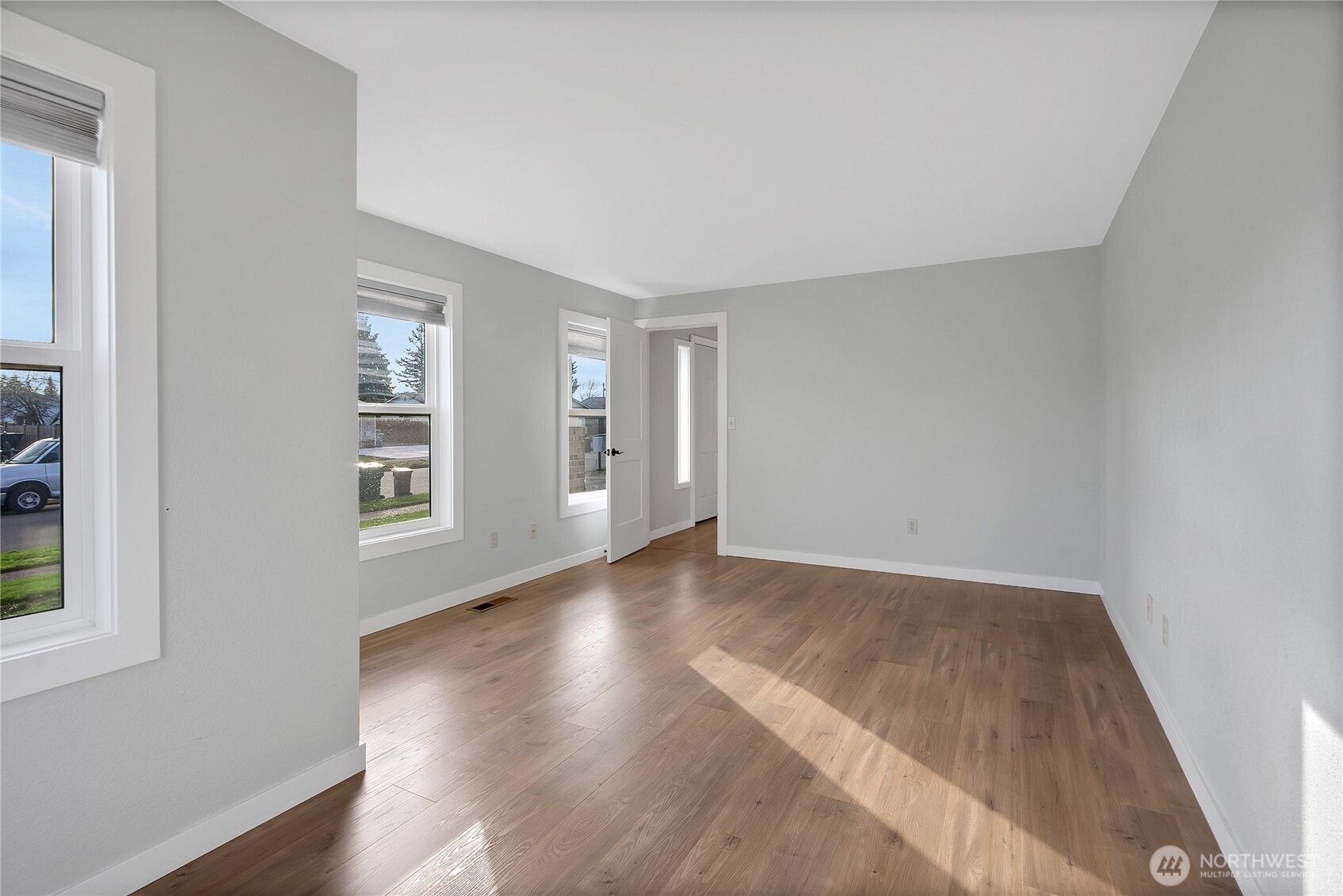 2881 Initial Avenue Enumclaw, WA 98022 - Photo 13 of 25 an empty room with wooden floor and windows