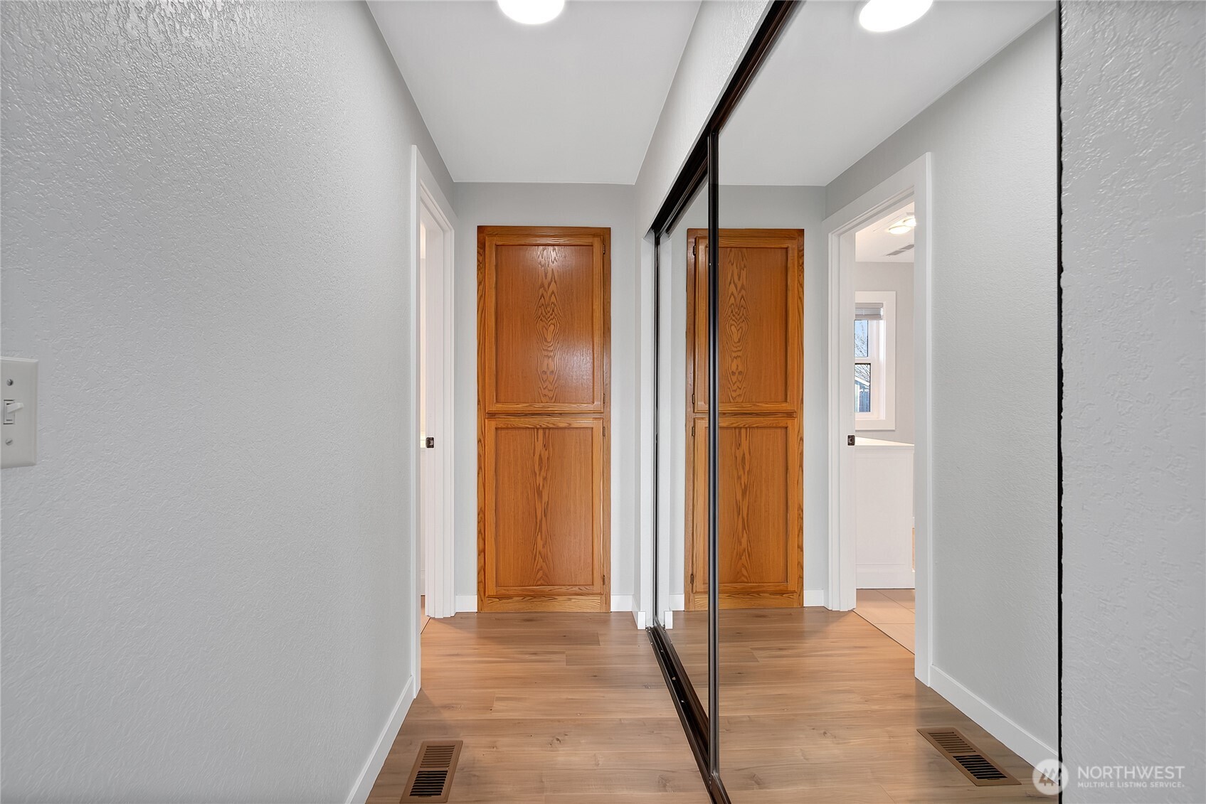 2881 Initial Avenue Enumclaw, WA 98022 - Photo 14 of 25 a view of a hallway with wooden floor and a bathroom