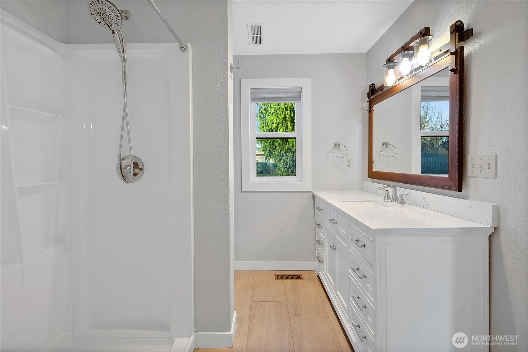 2881 Initial Avenue Enumclaw, WA 98022 - Photo 16 of 25 a bathroom with a double vanity sink mirror and shower