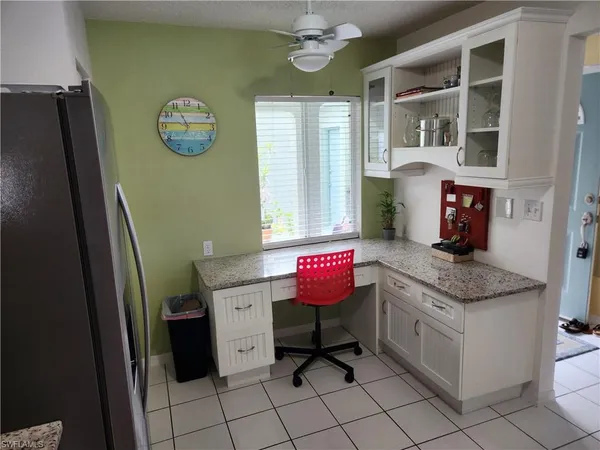 a room with a table chairs and a stove