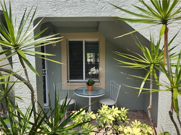 a backyard of a house with table and chairs