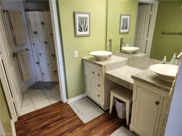 a bathroom with a sink a mirror and a shower