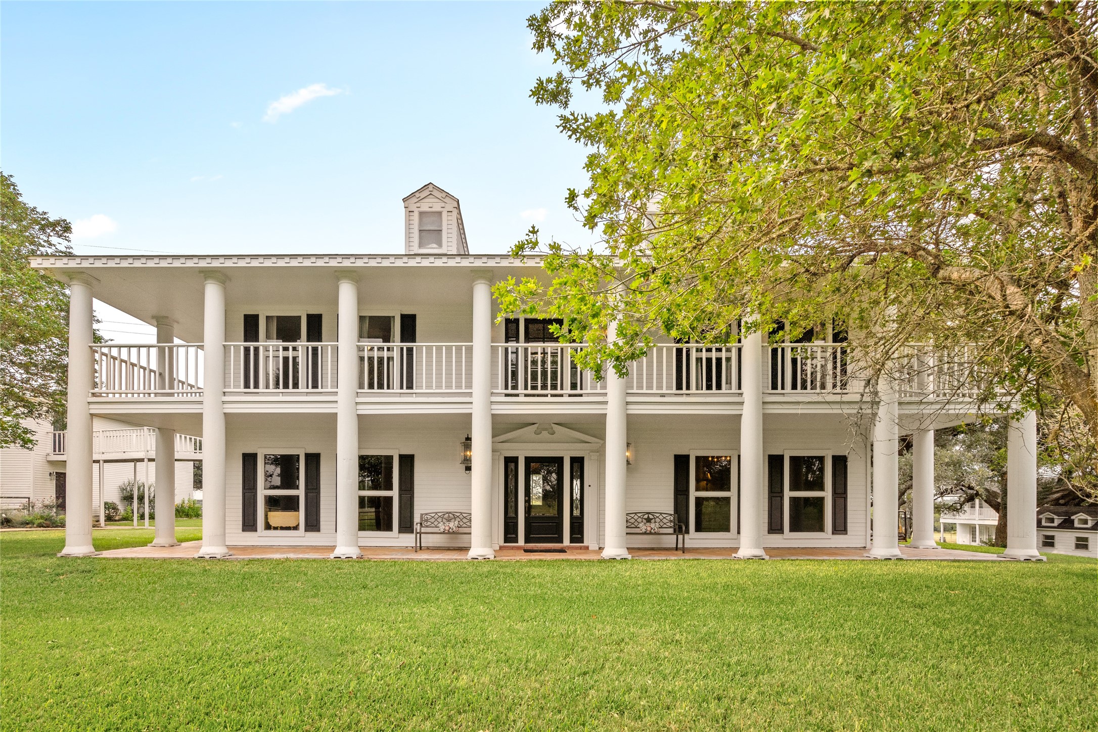 7023 Wolters Road Schulenburg, TX 78956 - Photo 1 of 49 a front view of a building with a garden