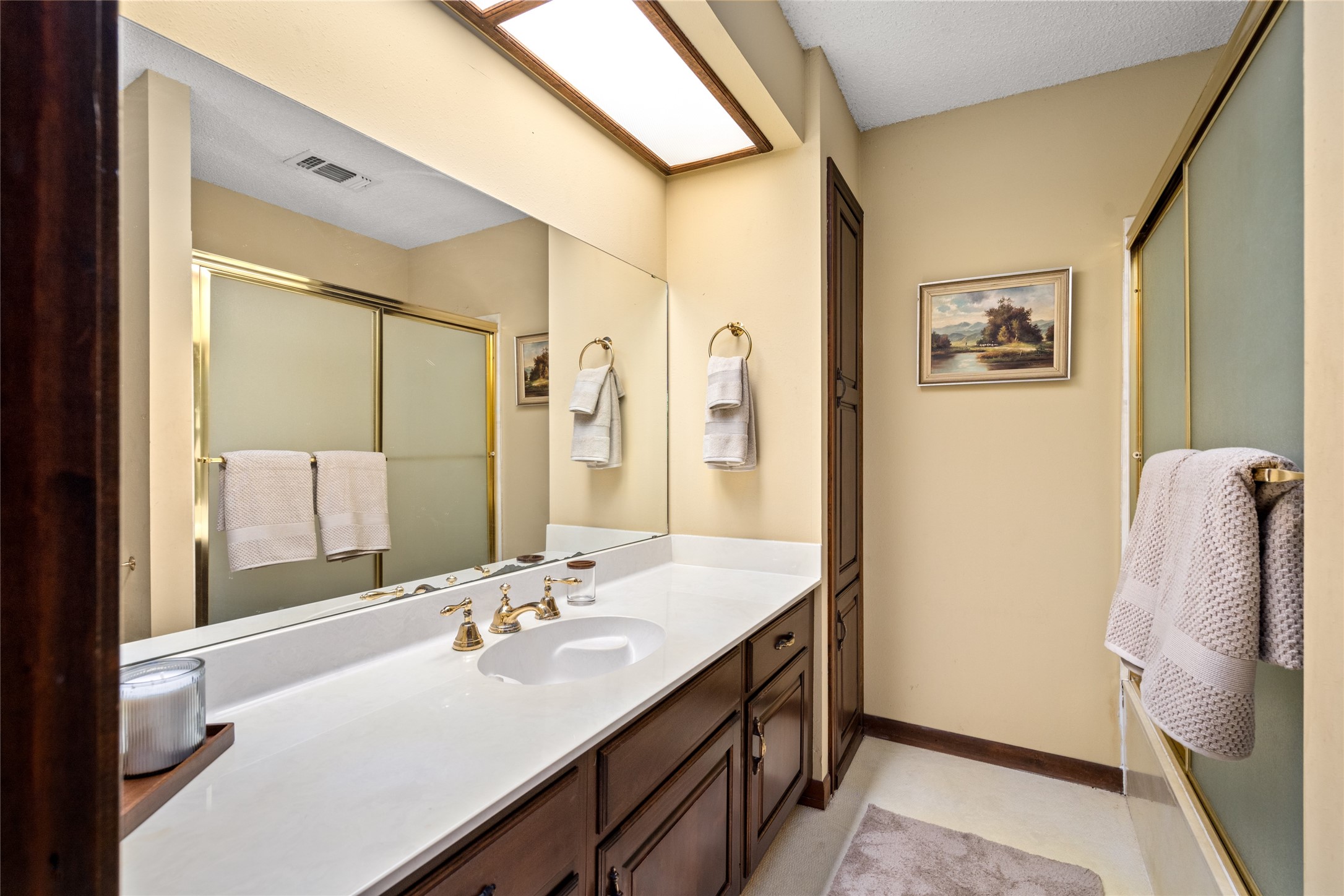 7023 Wolters Road Schulenburg, TX 78956 - Photo 24 of 49 a bathroom with a sink a mirror and a shower