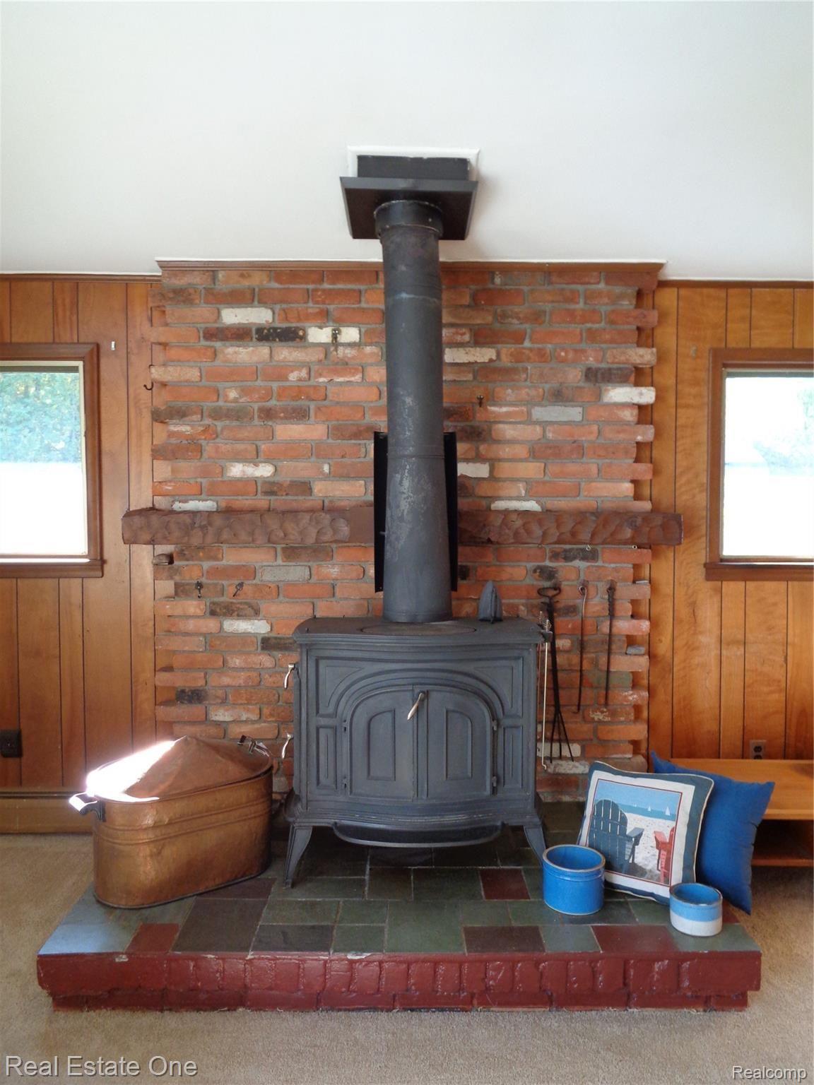 5960 Mills Road Deckerville, MI 48427 - Photo 16 of 79 Rustic, lodge-like woodburning fireplace. Cozy and warm.