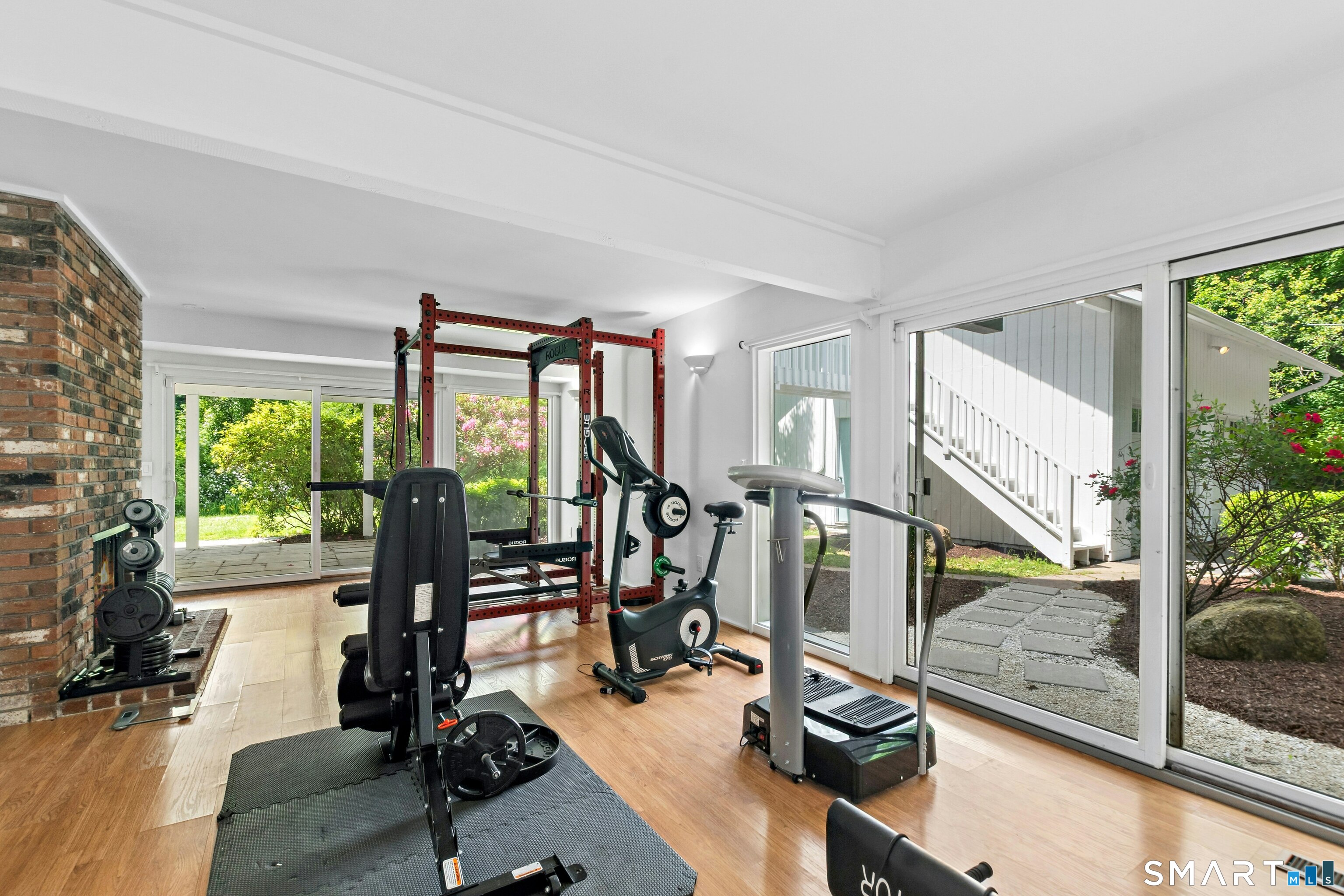 38 Old Redding Road Weston, CT 06883 - Photo 24 of 40 The Lower Level Family Room has an inviting fireplace and access to the patio. It is currently used as an Exercise Room