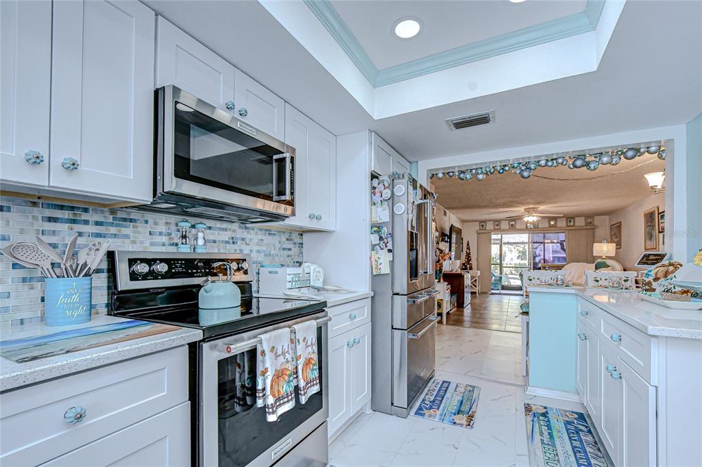 9700 Starkey Road, Unit 111 Seminole, FL 33777 - Photo 11 of 46 a kitchen with stainless steel appliances granite countertop a stove and cabinets
