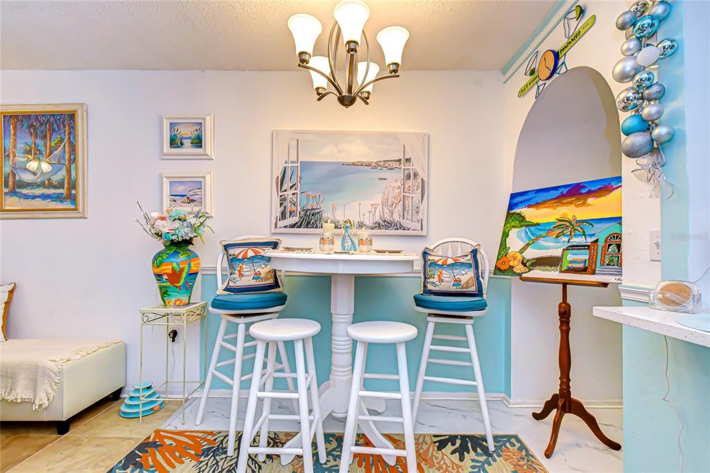 9700 Starkey Road, Unit 111 Seminole, FL 33777 - Photo 14 of 46 a view of a dining room with furniture and a chandelier