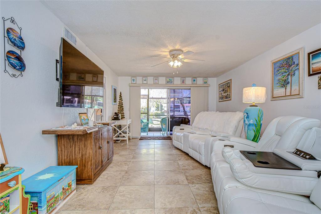 9700 Starkey Road, Unit 111 Seminole, FL 33777 - Photo 15 of 46 a living room with furniture and a dining room