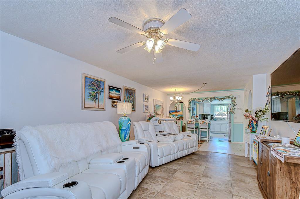 9700 Starkey Road, Unit 111 Seminole, FL 33777 - Photo 16 of 46 a living room with furniture and a chandelier