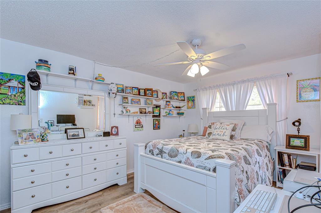 9700 Starkey Road, Unit 111 Seminole, FL 33777 - Photo 19 of 46 a bedroom with a bed and a chandelier