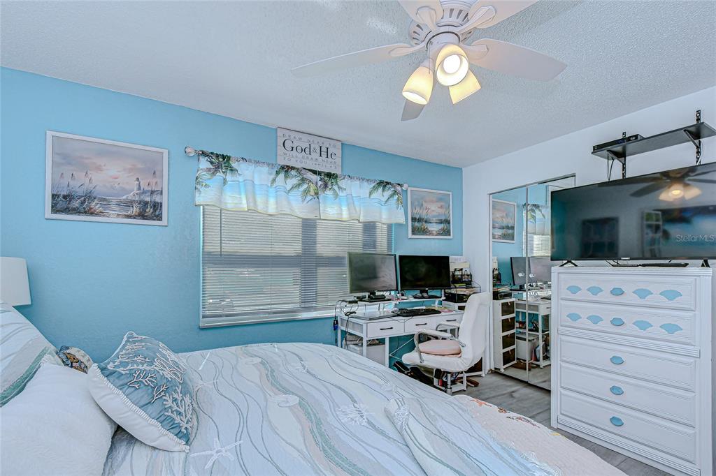 9700 Starkey Road, Unit 111 Seminole, FL 33777 - Photo 23 of 46 a bedroom with a bed and furniture