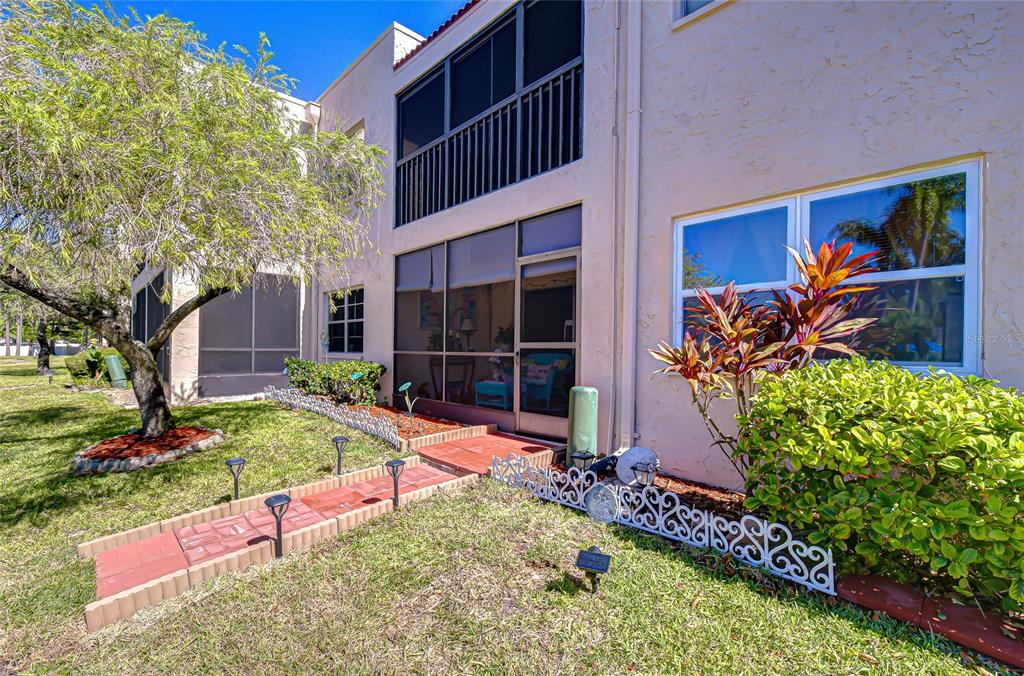 9700 Starkey Road, Unit 111 Seminole, FL 33777 - Photo 29 of 46 a view of backyard with potted plants and a bench