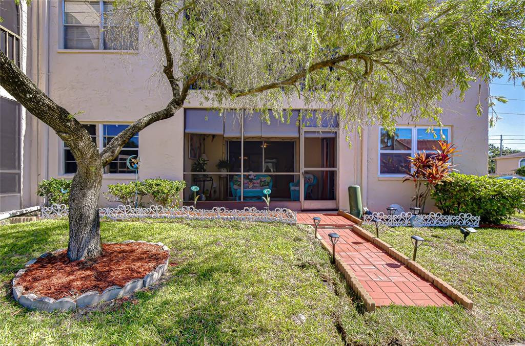 9700 Starkey Road, Unit 111 Seminole, FL 33777 - Photo 30 of 46 a view of a house with swimming pool and a garden