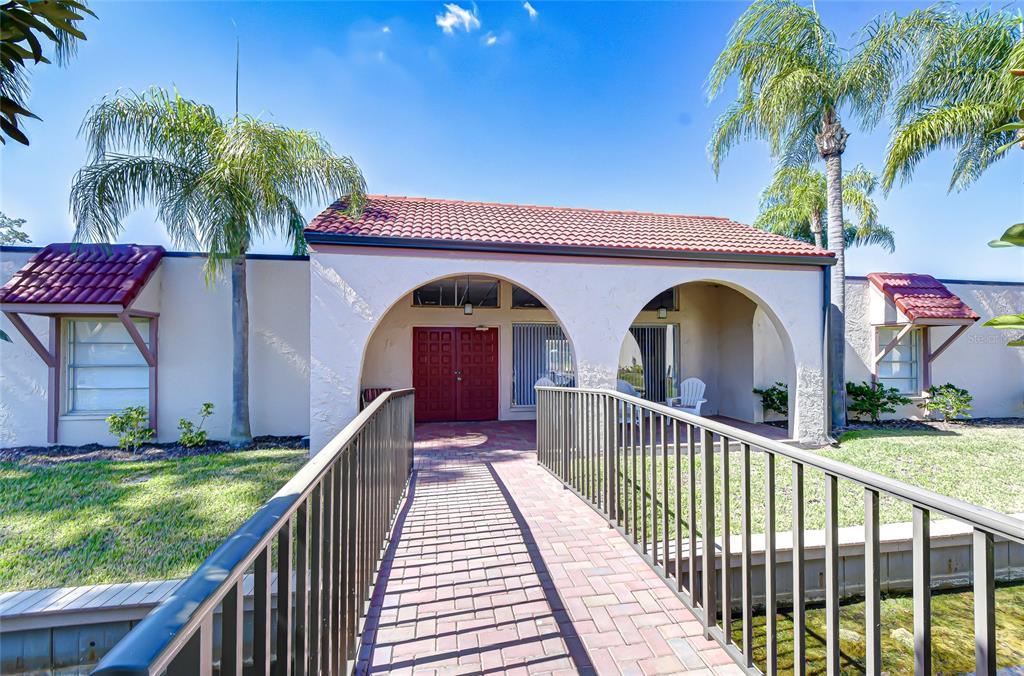 9700 Starkey Road, Unit 111 Seminole, FL 33777 - Photo 34 of 46 a view of house with swimming pool and glass windows