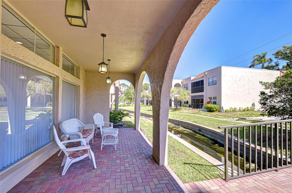 9700 Starkey Road, Unit 111 Seminole, FL 33777 - Photo 35 of 46 a view of a chairs and table in the balcony