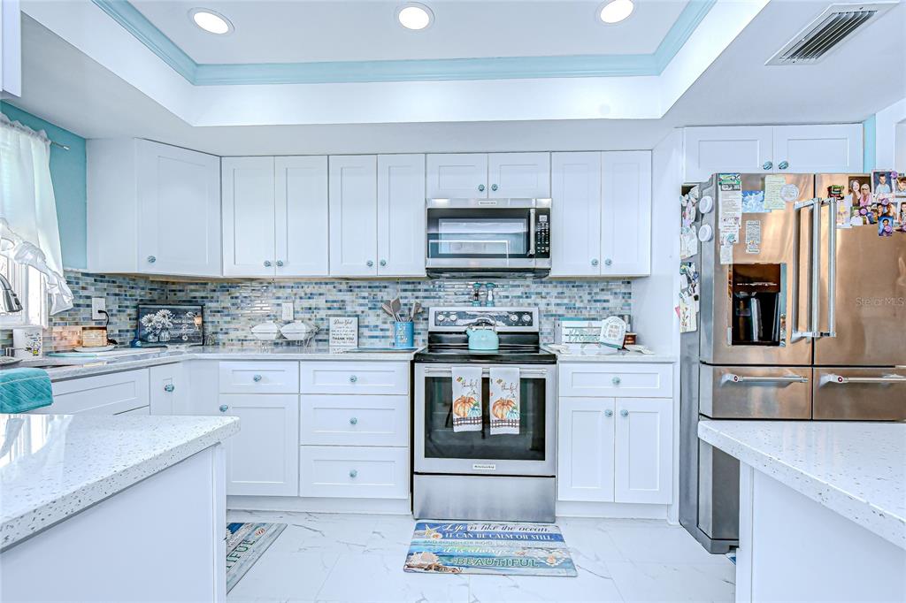9700 Starkey Road, Unit 111 Seminole, FL 33777 - Photo 4 of 46 a kitchen with granite countertop a sink stove and refrigerator