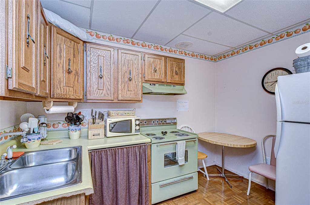 9700 Starkey Road, Unit 111 Seminole, FL 33777 - Photo 45 of 46 a kitchen with a sink cabinets and appliances