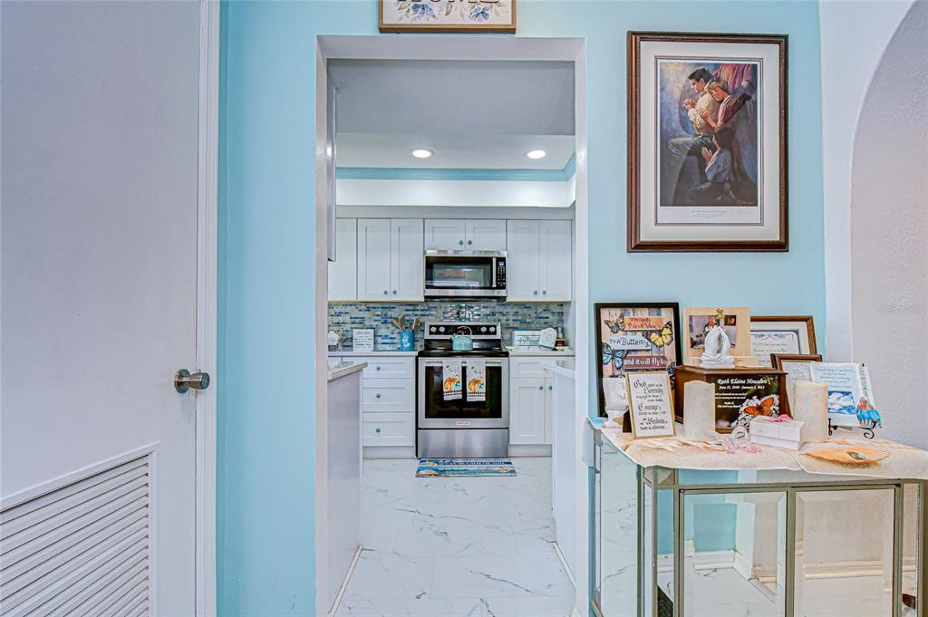 9700 Starkey Road, Unit 111 Seminole, FL 33777 - Photo 8 of 46 a kitchen with stainless steel appliances granite countertop a stove and a refrigerator